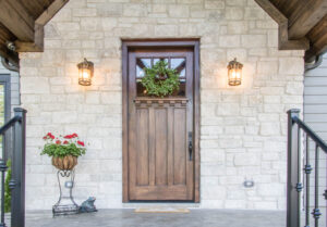 a front entry door with rich woodgrain pattern and upper window